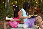 Free Stock Photo: Two cute young girls reading books outdoors