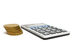 Free Stock Photo: A calculator and a stack of gold coins