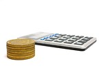 Free Stock Photo: A calculator and a stack of gold coins