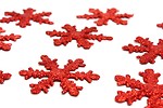 Free Stock Photo: Red snowflake shaped Christmas ornaments isolated on a white background