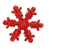 Free Stock Photo: A red snowflake shaped Christmas ornament isolated on a white background