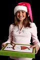 Free Stock Photo: A beautiful young girl in a pink santa hat holding a present