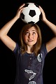 Free Stock Photo: A cute young girl posing with a soccer ball