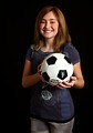 Free Stock Photo: A cute young girl posing with a soccer ball