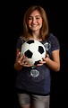 Free Stock Photo: A cute young girl posing with a soccer ball.