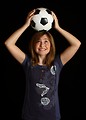 Free Stock Photo: A cute young girl posing with a soccer ball