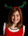 Free Stock Photo: A cute young girl posing in a Christmas outfit