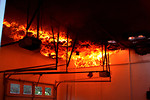 Free Stock Photo: Flames rolling over the ceiling of a garage fire.