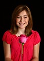 Free Stock Photo: A cute young girl posing with a pink rose