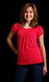Free Stock Photo: A cute young girl in a pink shirt posing on a black background