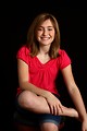 Free Stock Photo: A cute young girl in a pink shirt posing on a black background