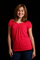 Free Stock Photo: A cute young girl in a pink shirt posing on a black background