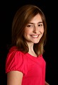 Free Stock Photo: A cute young girl in a pink shirt posing on a black background