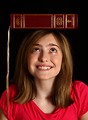 Free Stock Photo: A cute young girl balancing a book on her head
