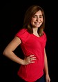 Free Stock Photo: A cute young girl posing in a pink shirt on a black background