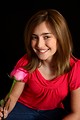 Free Stock Photo: A cute young girl posing with a pink rose