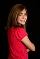 Free Stock Photo: A cute young girl in a pink shirt posing on a black background