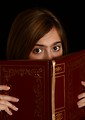 Free Stock Photo: A cute young girl reading a book