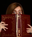 Free Stock Photo: A cute young girl reading a book