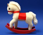 Free Stock Photo: A stuffed rocking horse isolated on a blue background