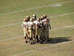 Free Stock Photo: A football team in a huddle on a field