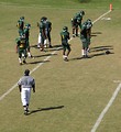 Free Stock Photo: Football players on a field with a referee