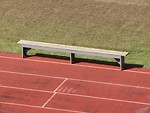 Free Stock Photo: An empty bench on a track field