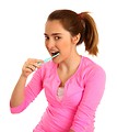 Free Stock Photo: A cute young girl brushing her teeth