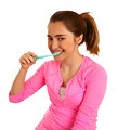 Free Stock Photo: A cute young girl brushing her teeth