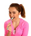 Free Stock Photo: A cute young girl brushing her teeth