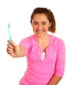 Free Stock Photo: A cute young girl holding a tooth brush