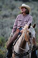 Free Stock Photo: A cowgirl riding a horse.