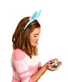 Free Stock Photo: A cute young girl dressed in bunny ears holding Easter eggs