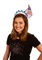 Free Stock Photo: A cute young girl dressed up for the 4th of July holding a small American flag