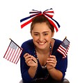 Free Stock Photo: A cute young girl dressed up for the 4th of July holding small American flags