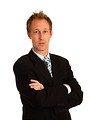 Free Stock Photo: A young businessman with crossed arms isolated on a white background