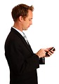 Free Stock Photo: A young businessman using a smart phone