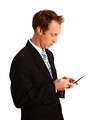 Free Stock Photo: A young businessman texting on a cell phone