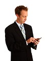 Free Stock Photo: A young businessman in a suit using a calculator
