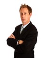 Free Stock Photo: A young businessman in a suit crossing his arms