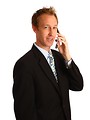 Free Stock Photo: A young businessman talking on a cell phone
