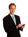 Free Stock Photo: A young businessman in a suit using a calculator