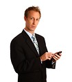 Free Stock Photo: A young businessman using a smart phone