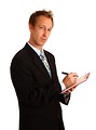 Free Stock Photo: A young businessman holding a clipboard and pen