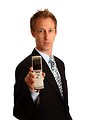 Free Stock Photo: A young businessman holding a cell phone