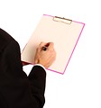 Free Stock Photo: A young businessman holding a clipboard and pen