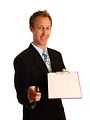 Free Stock Photo: A young businessman holding a clipboard and pen