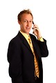 Free Stock Photo: A young businessman in a suit talking on a cell phone