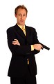 Free Stock Photo: A young businessman in a suit holding a pistol
