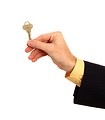 Free Stock Photo: A hand in a business suit holding a key.
